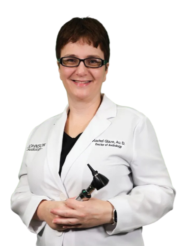 A woman in a lab coat is holding an ear scope