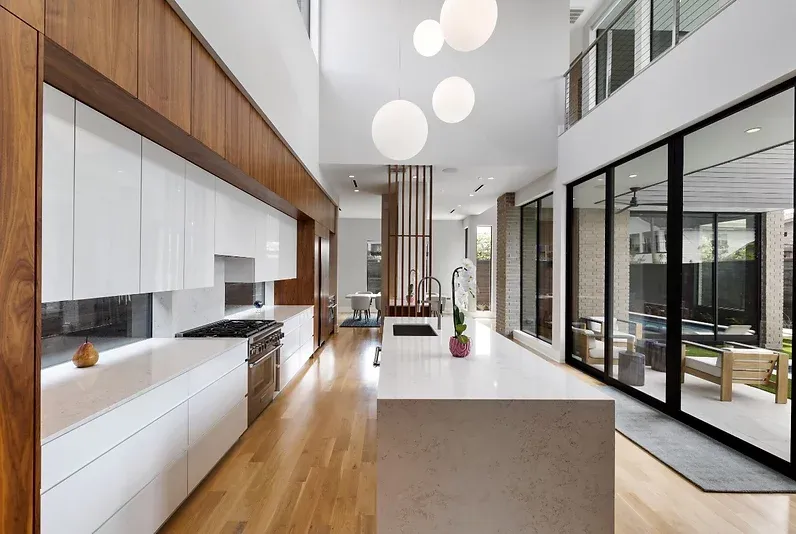 A kitchen with a large island and sliding glass doors
