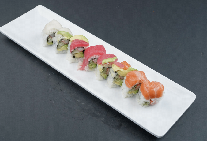 Assorted sushi rolls and nigiri on a long white rectangular plate