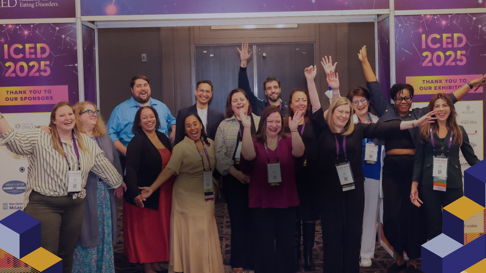 Group of people posing outside an ICED 2025 venue with purple banners and raised hands