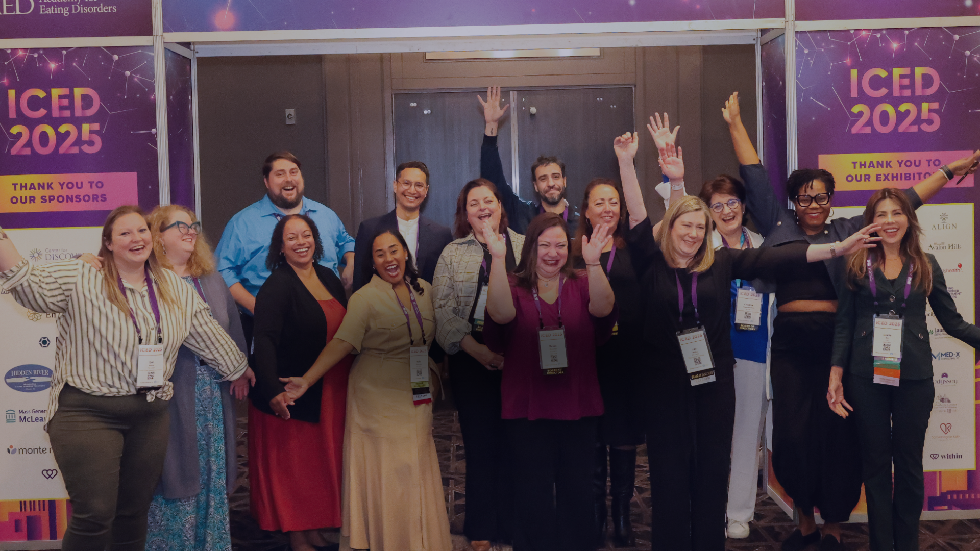 Group of smiling conference attendees posing in front of an ICED 2025 backdrop.