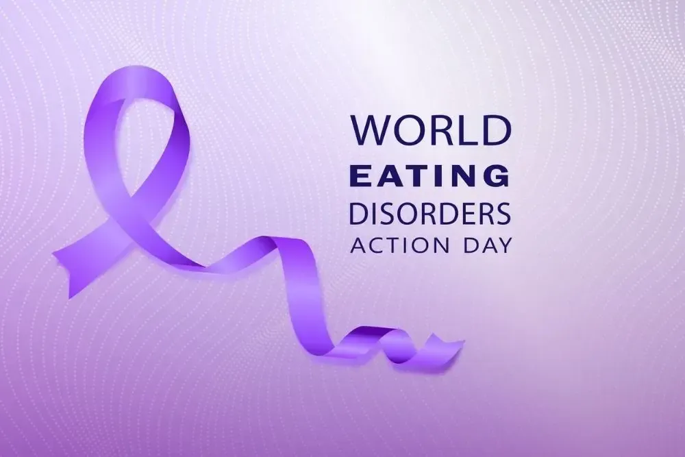 Purple ribbon with “World Eating Disorders Action Day” text on a light purple background