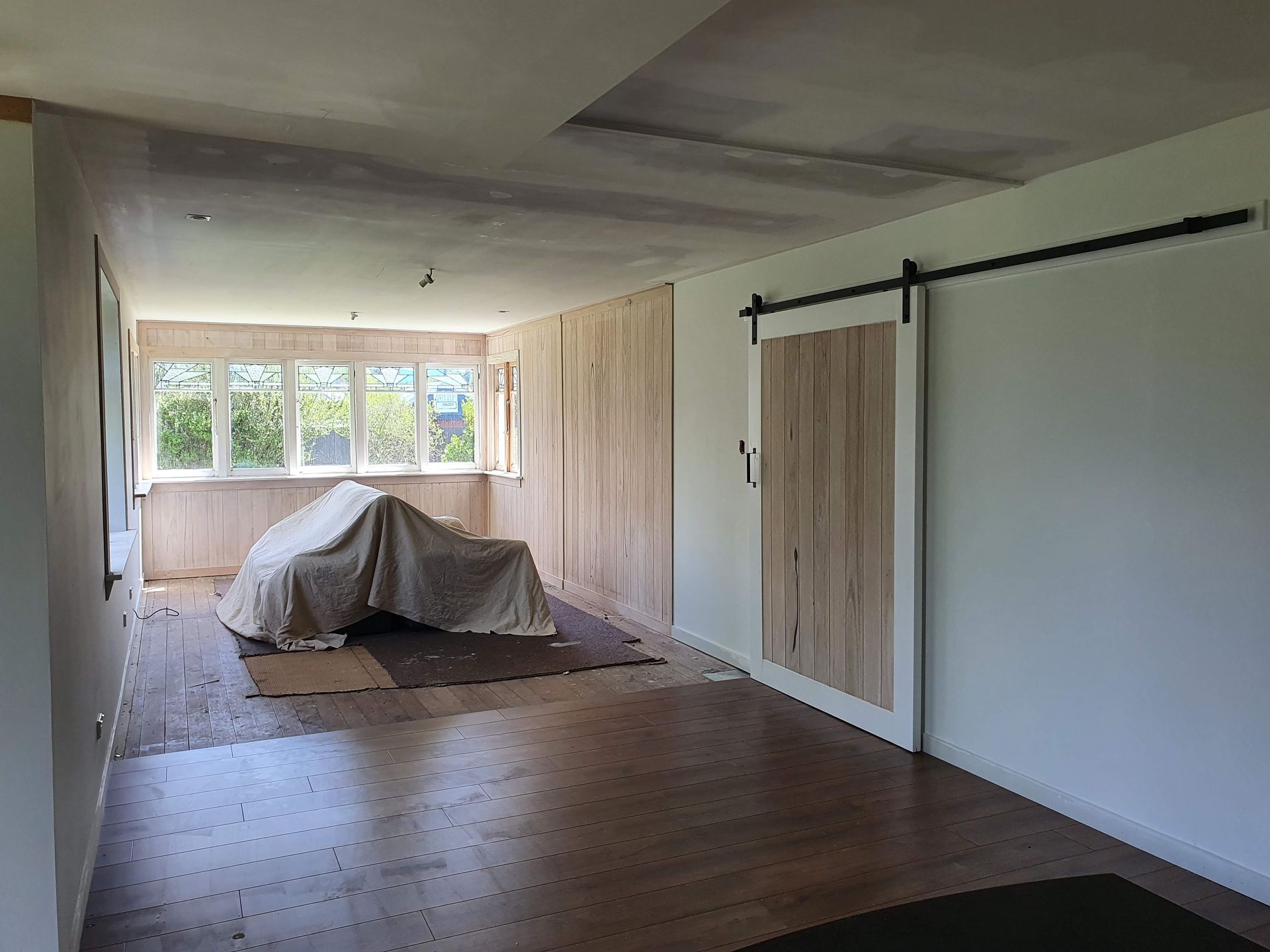 There is a sliding barn door in the middle of the room.