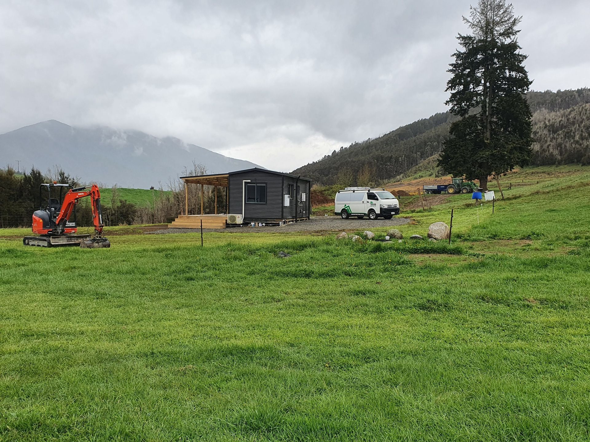A house is being built in the middle of a grassy field.