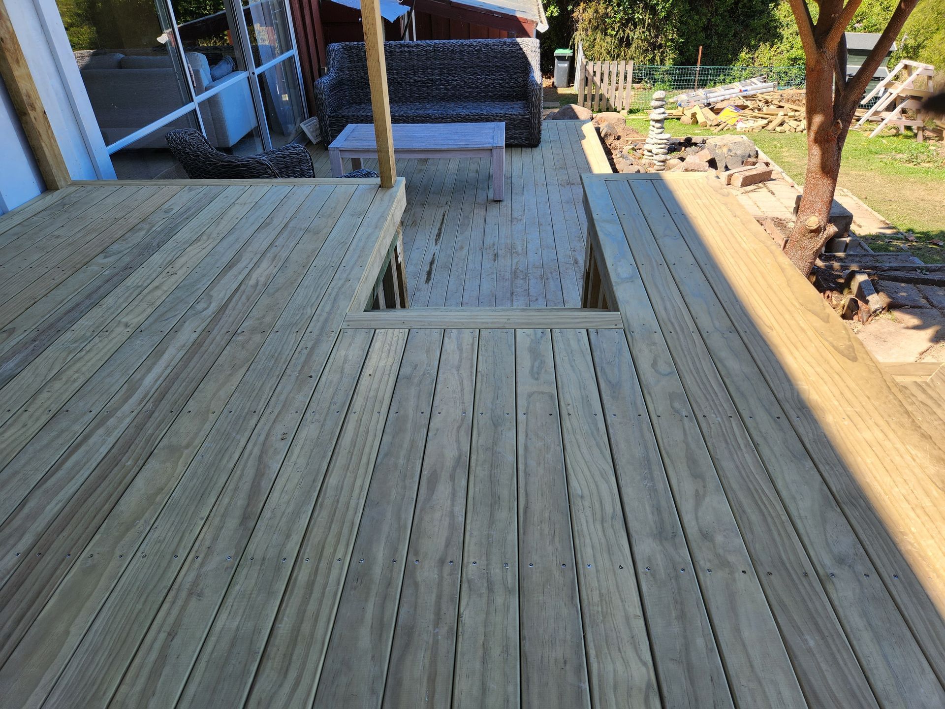 A wooden deck with a staircase leading up to it.