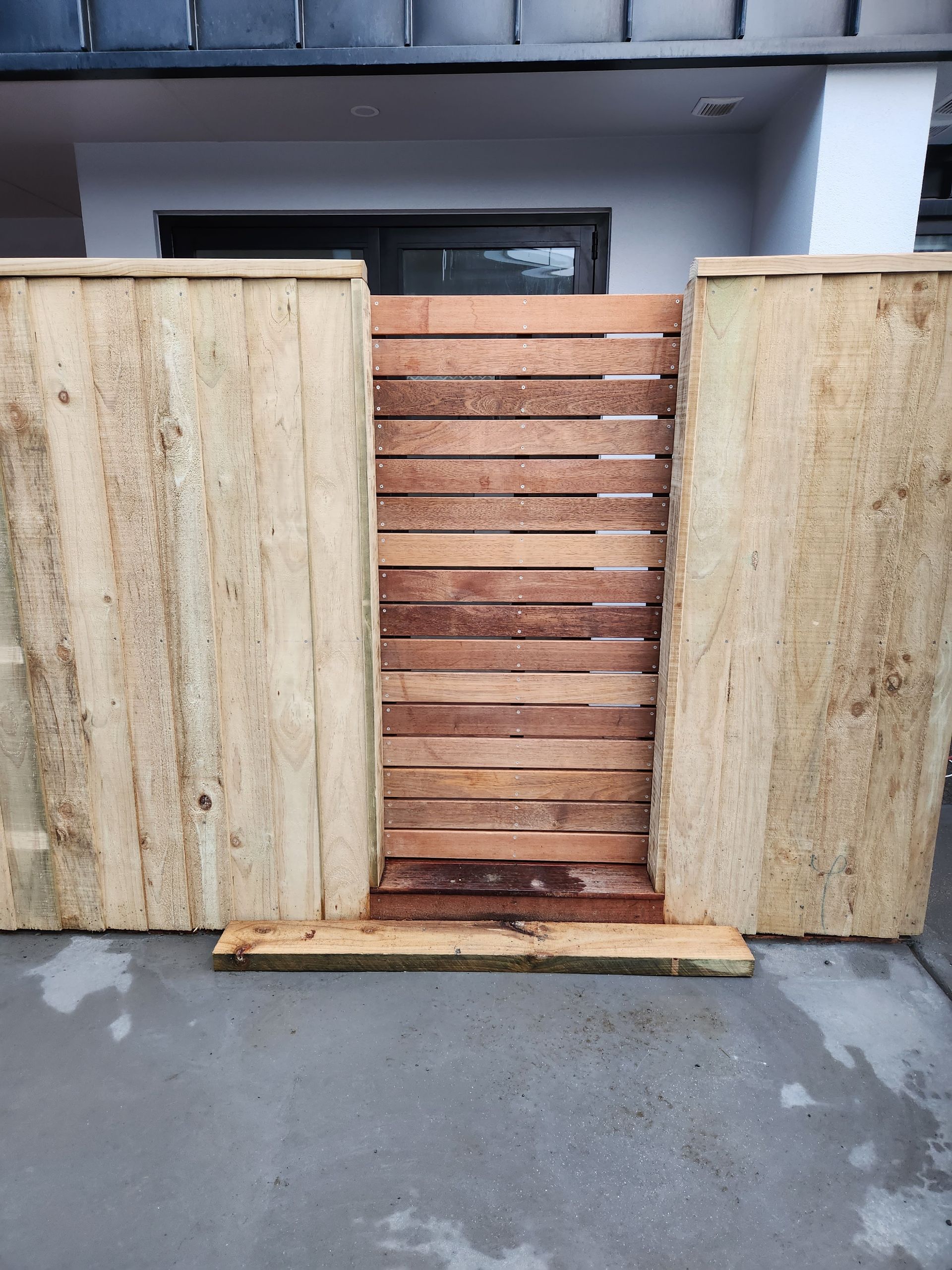 A wooden fence with a gate in the middle of it
