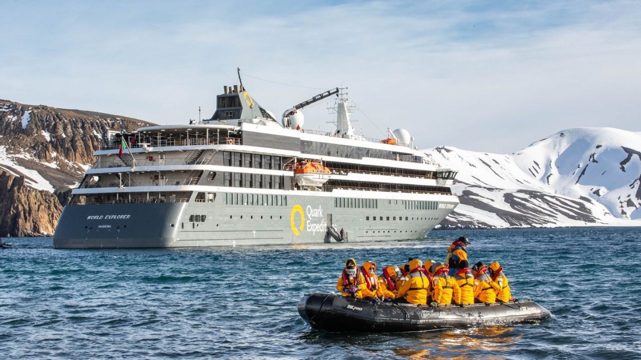 A group of people are riding a raft in front of a large cruise ship.
