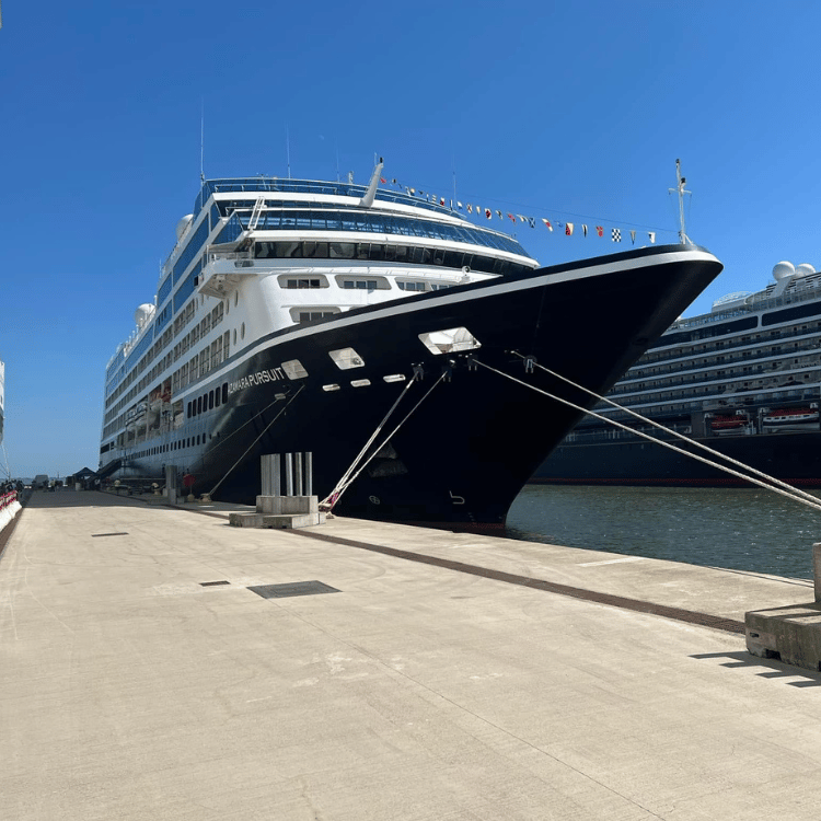 Emerald Caya luxury superyacht docked in a Croatian coastal port with medieval stone buildings in th