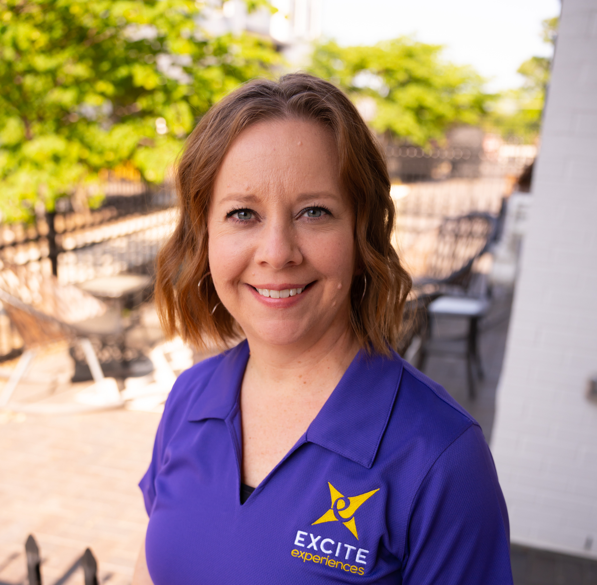 Woman wearing purple polo shirt with 