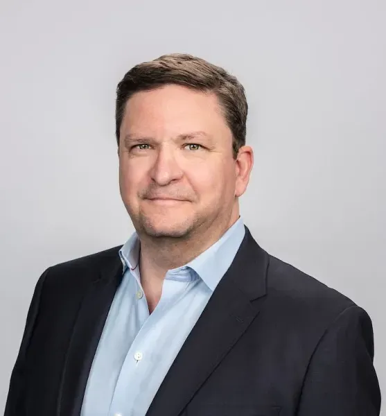 A headshot of a men in suit.