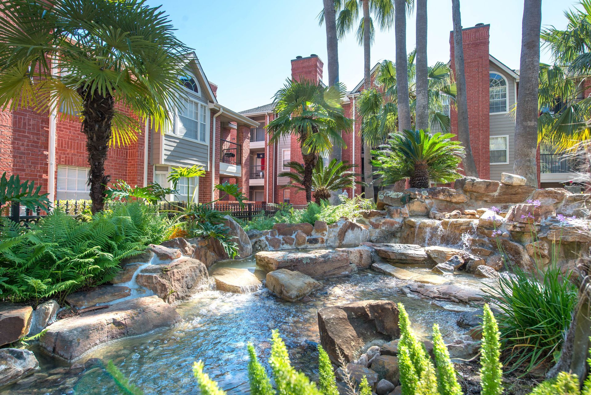 Apartment community with waterfall.