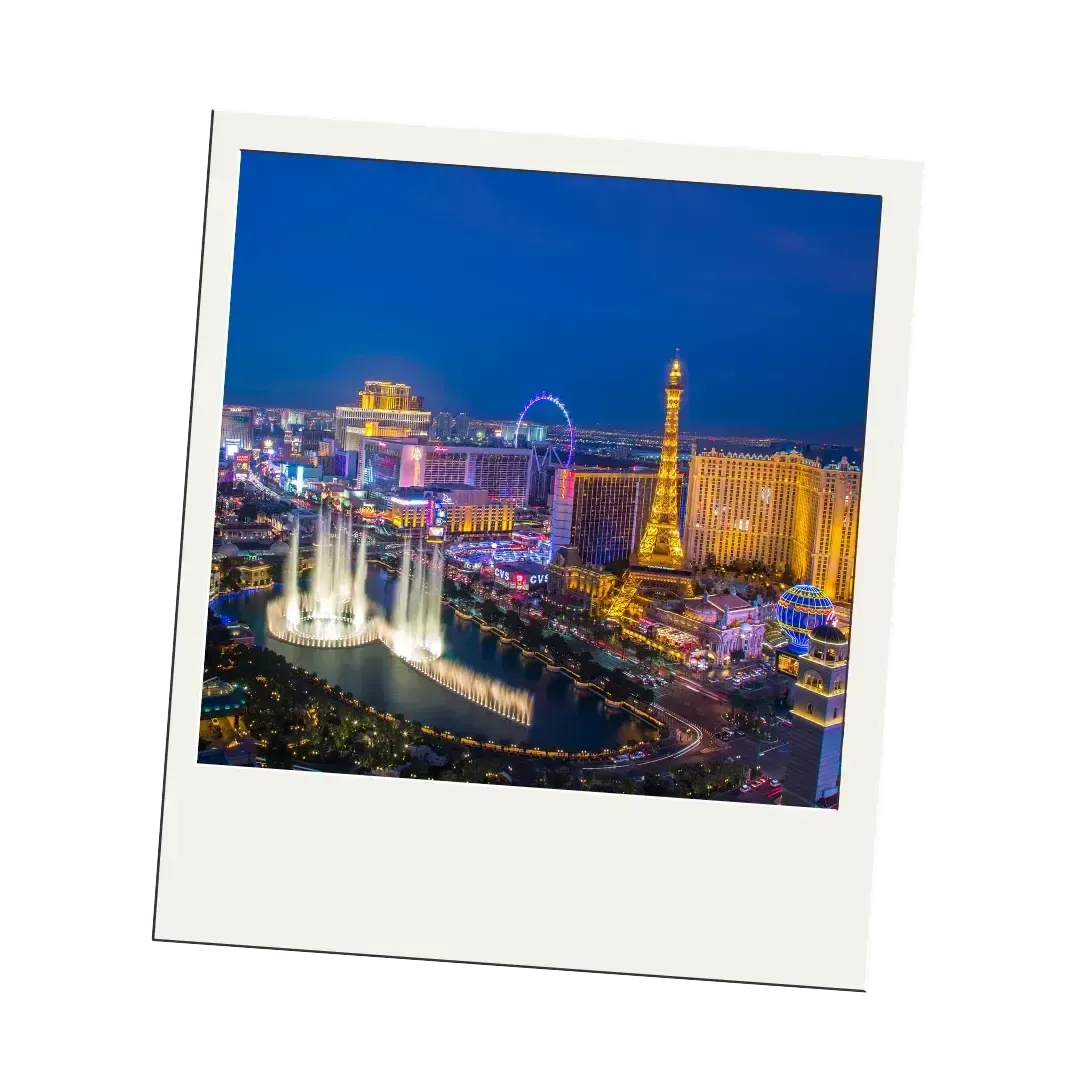 A polaroid picture of las vegas at night with a fountain in the foreground.