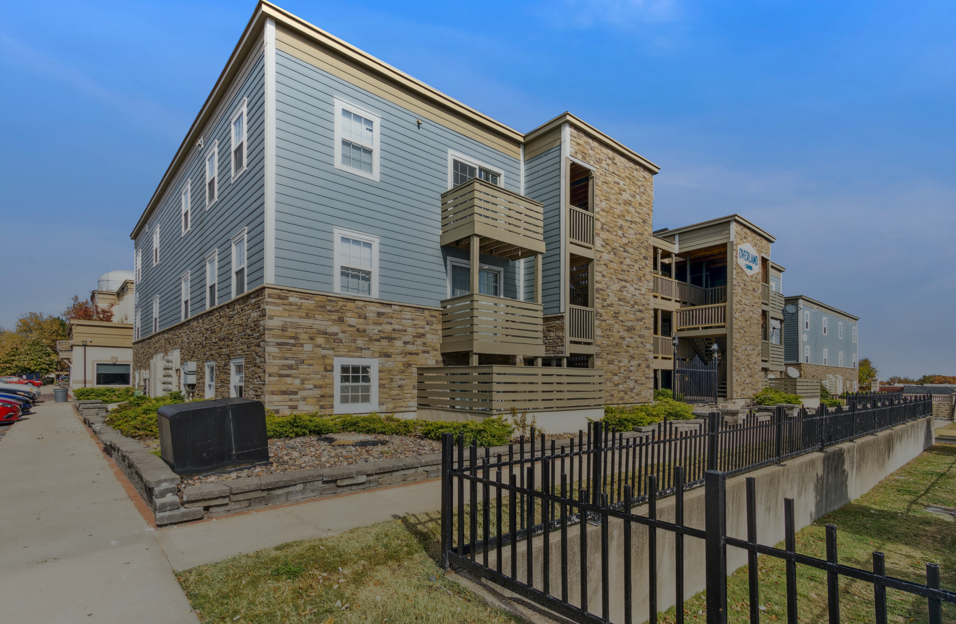 A large apartment building with a fence around it.