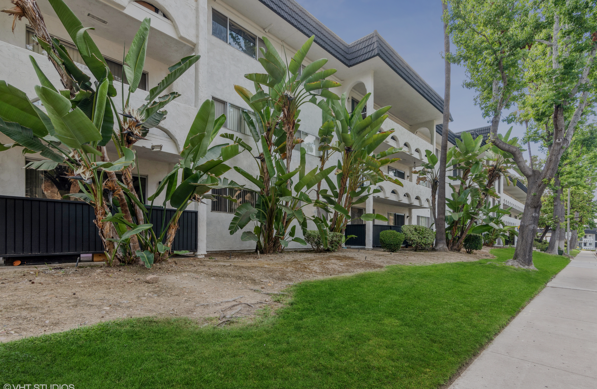A building with a lot of plants in front of it