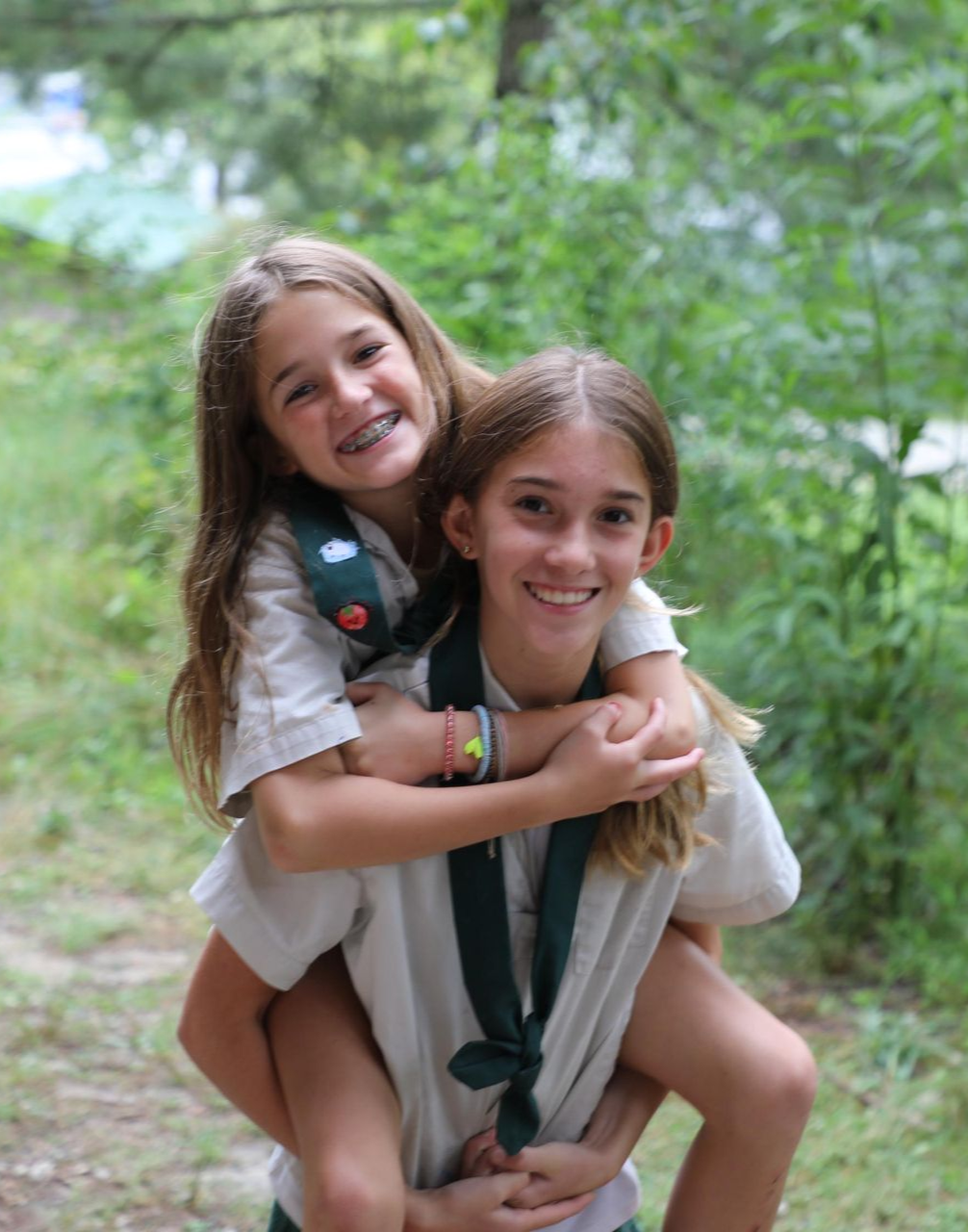 Two girls smile at the camera