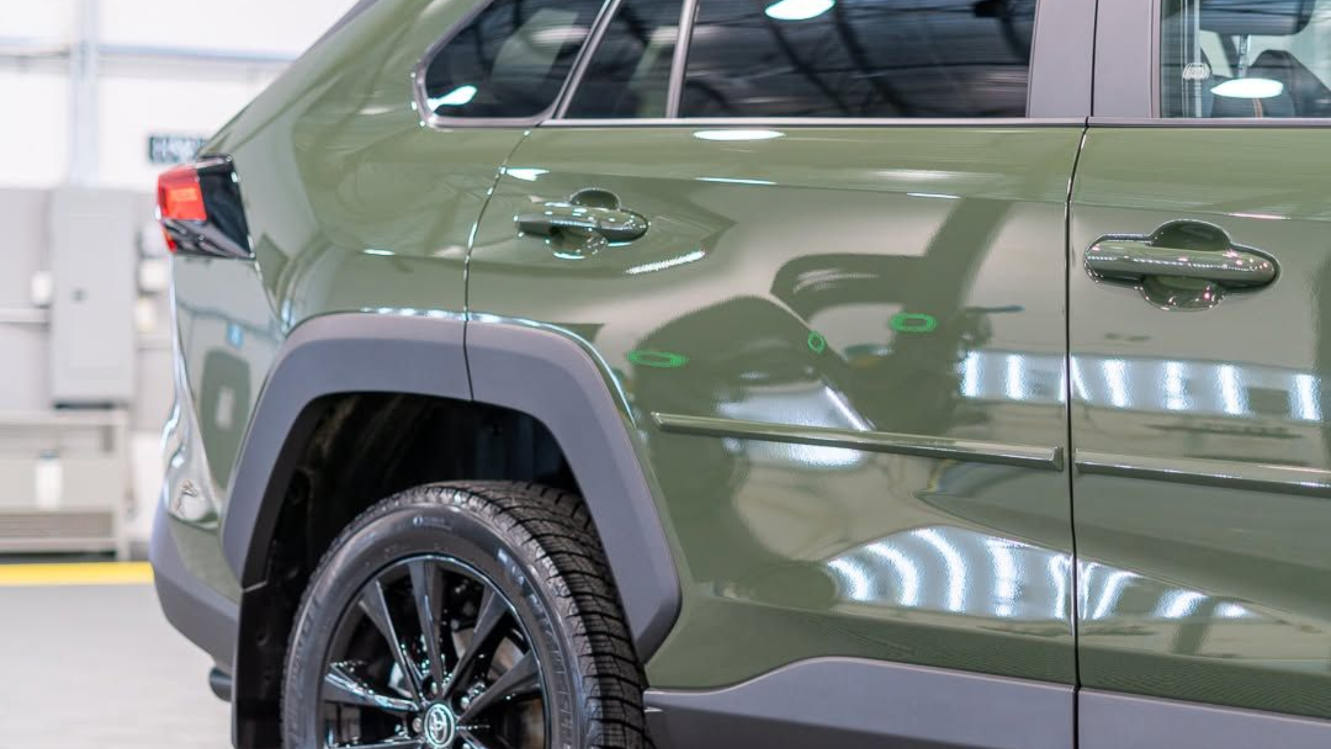 Green SUV, black accents, side view showing tire, door handle, and window.