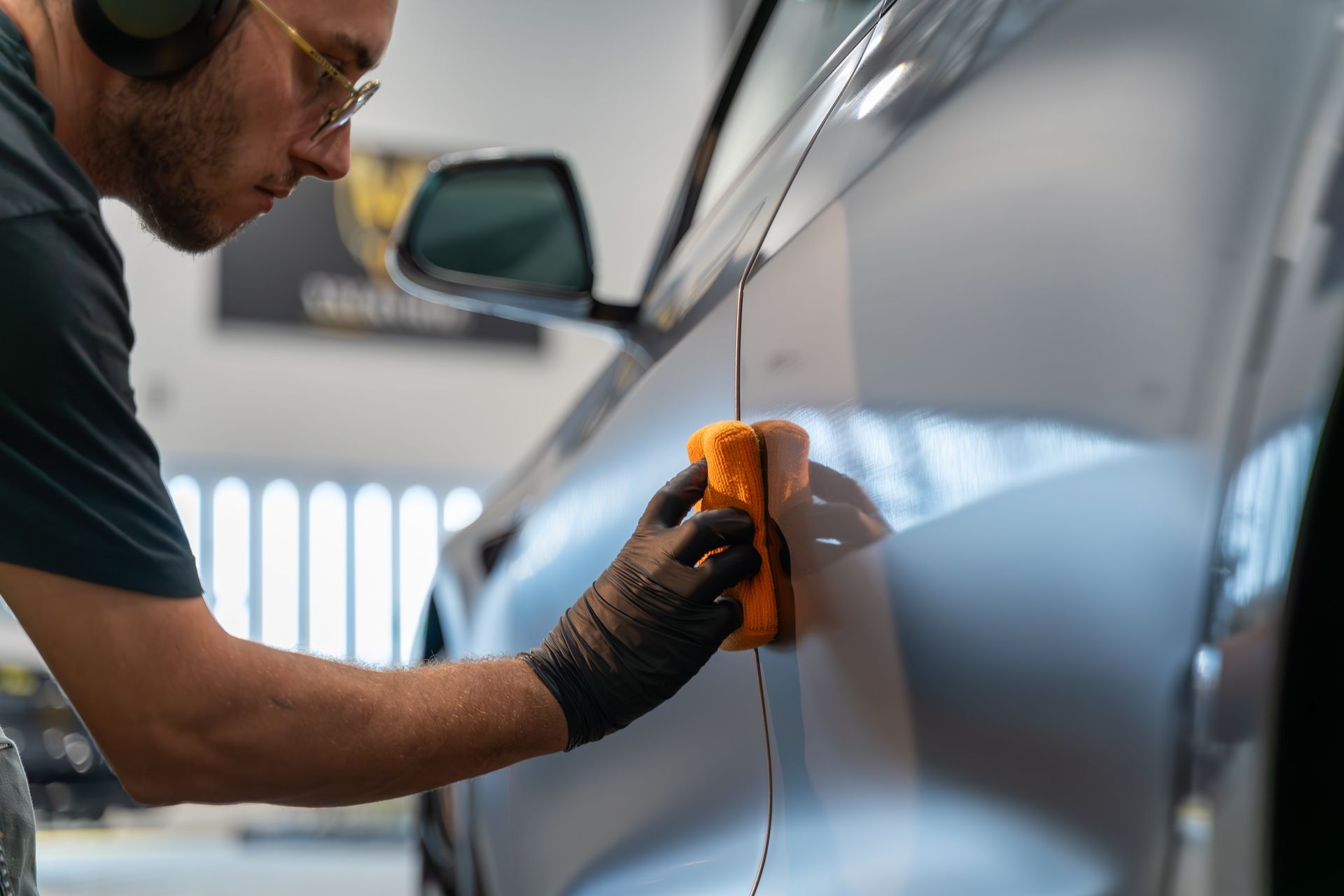 A man is working on a tire in a garage.