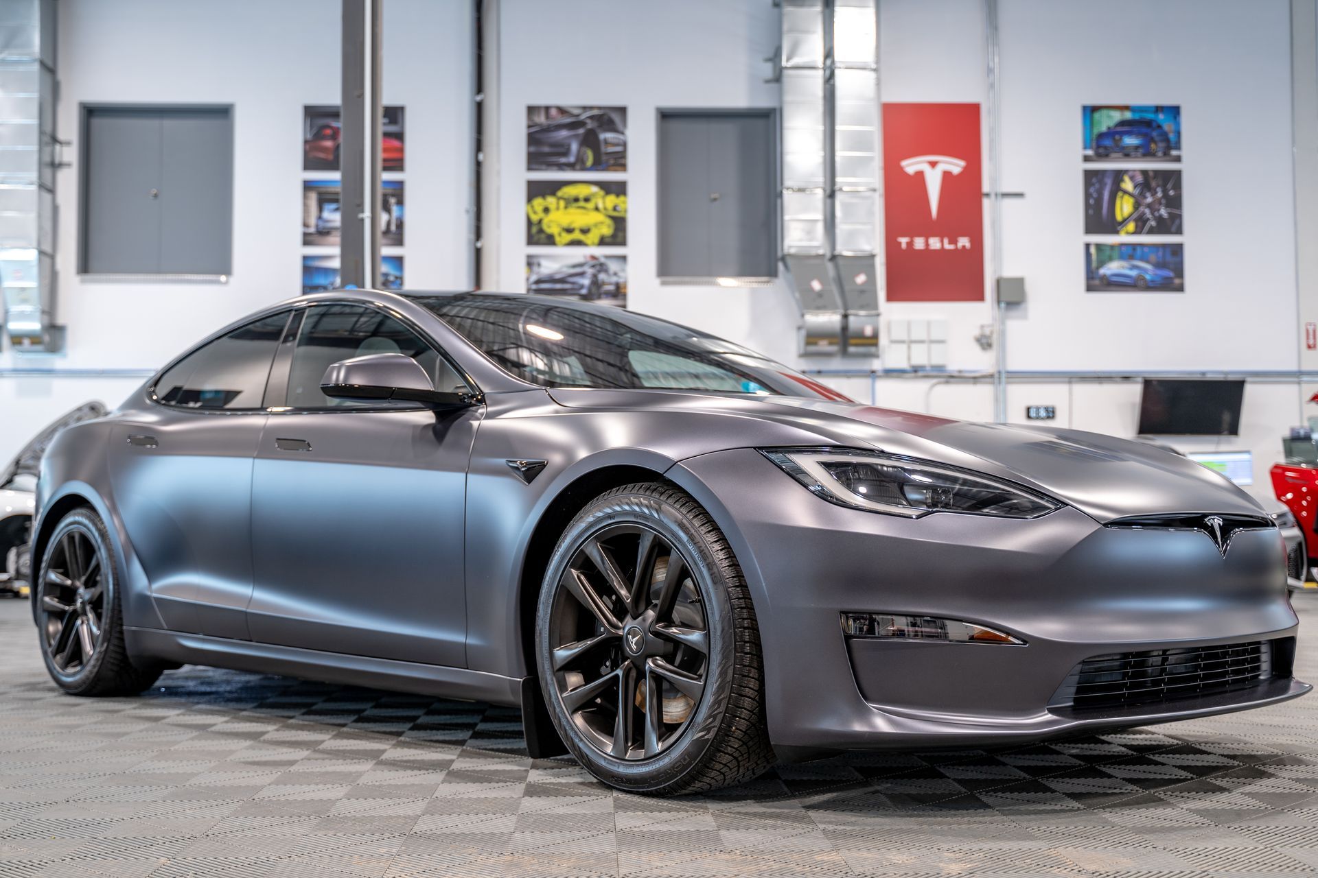A tesla model s is parked in a garage.