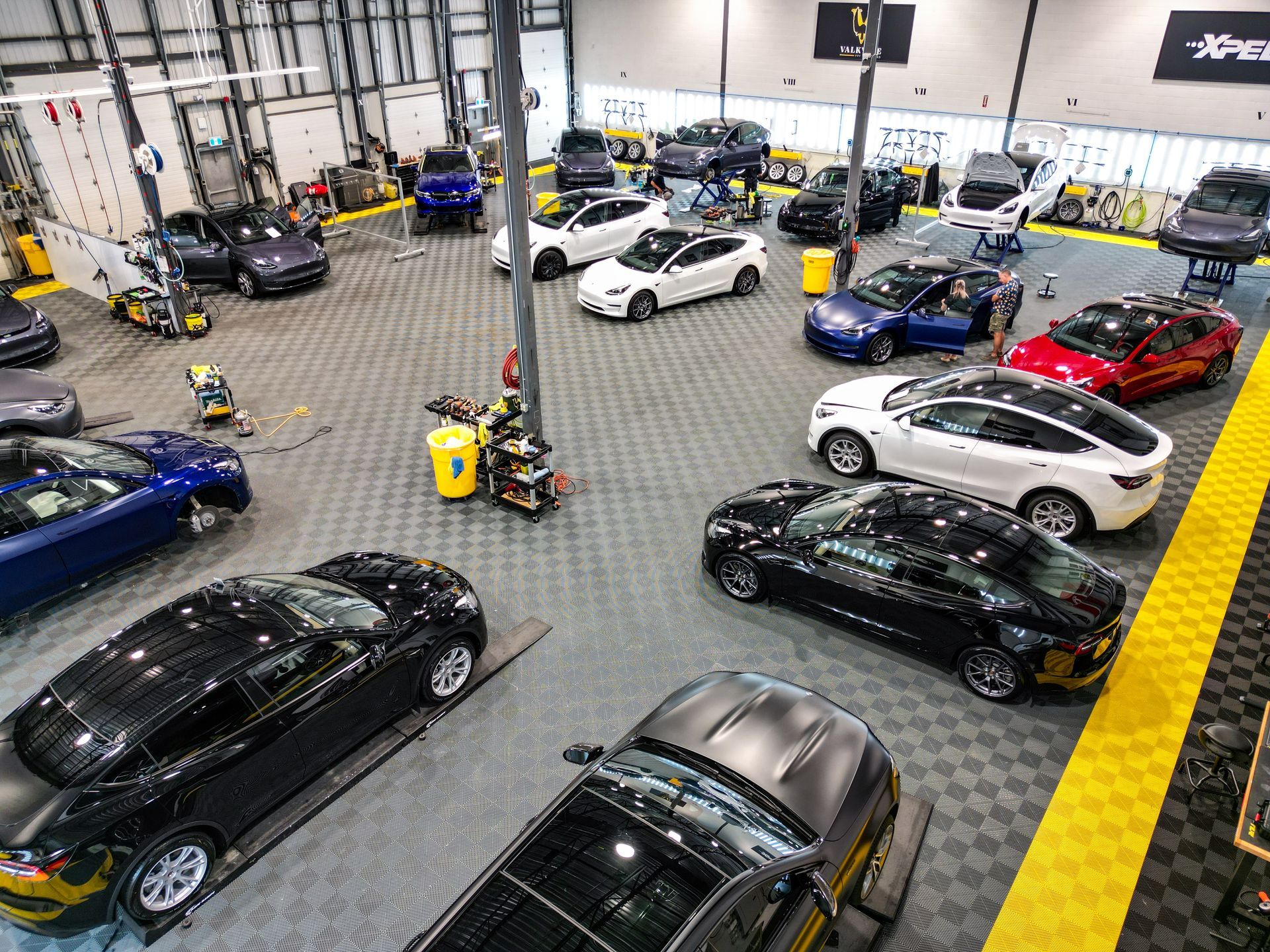 A lot of cars are parked in a garage.