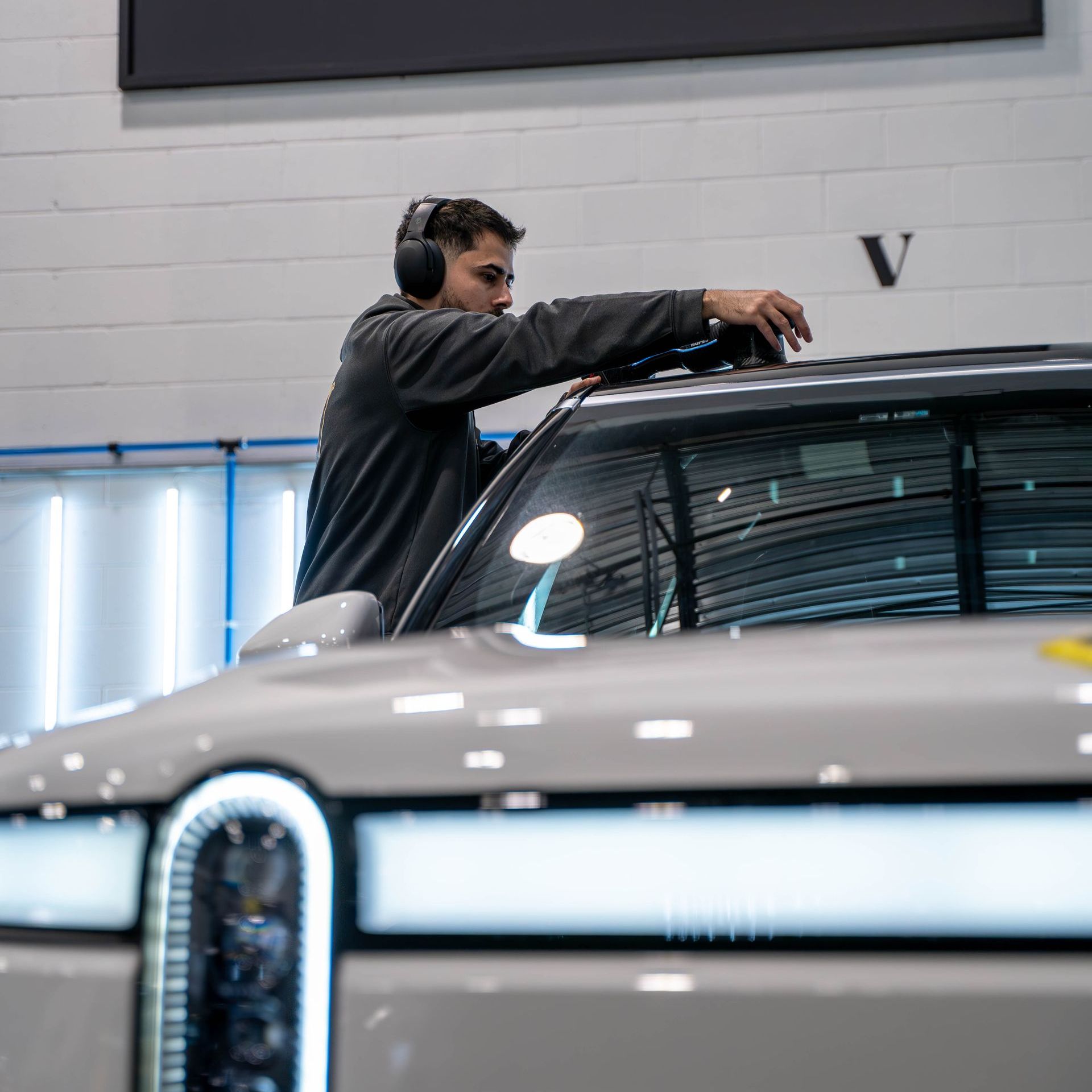 A man is working on a car in a garage.