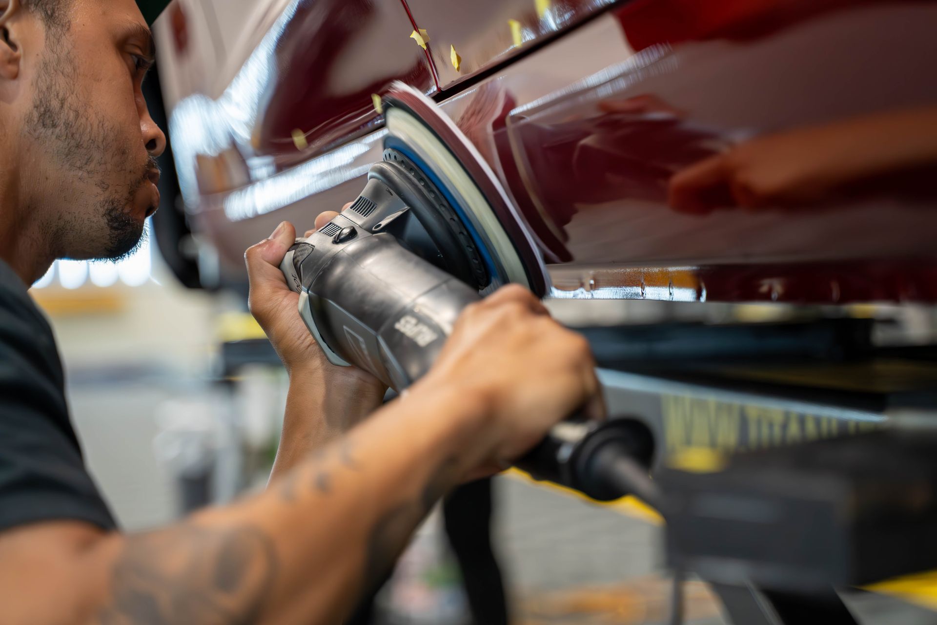 A man is working on a car in a garage.