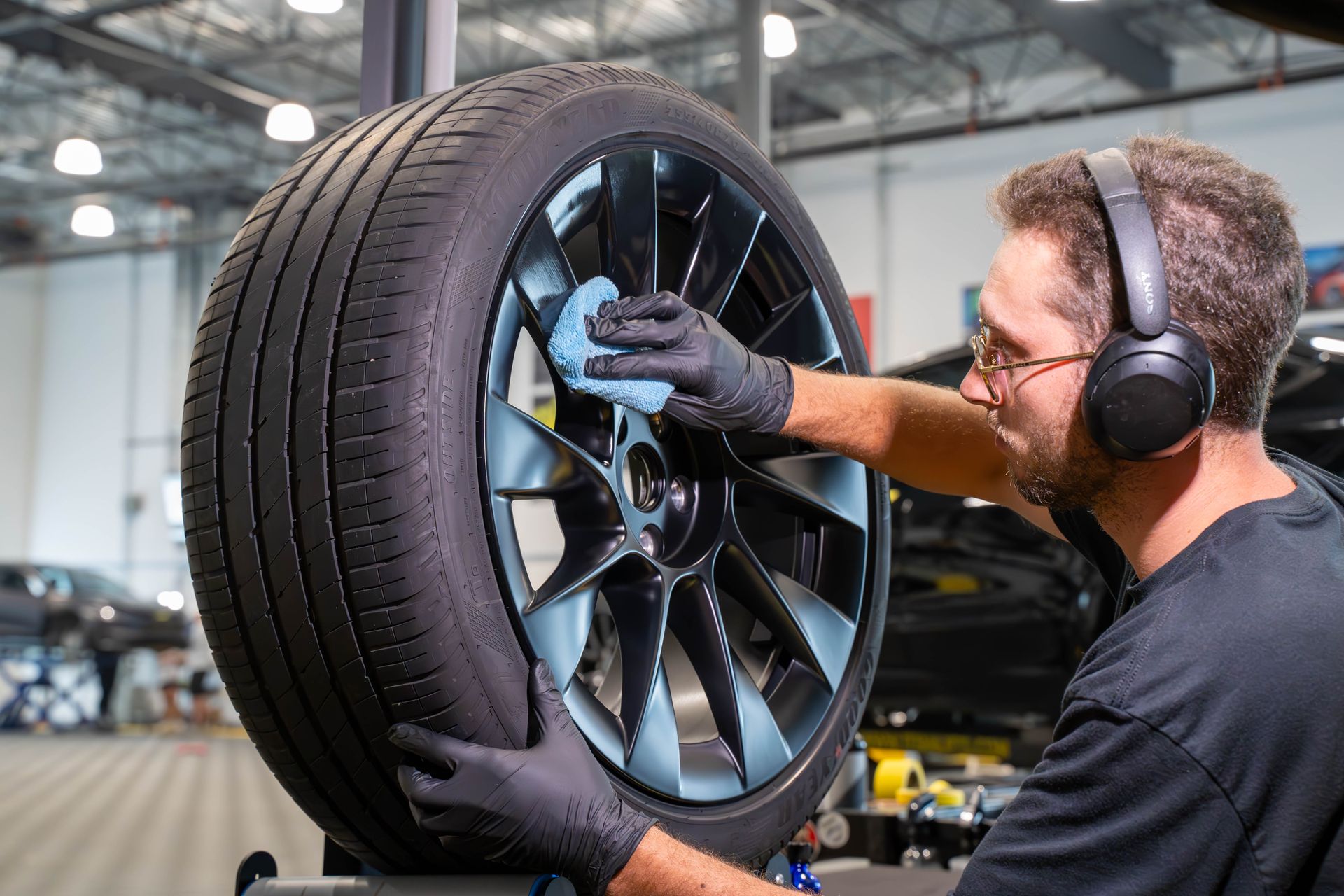 A close up of a car wheel with red brake calipers.