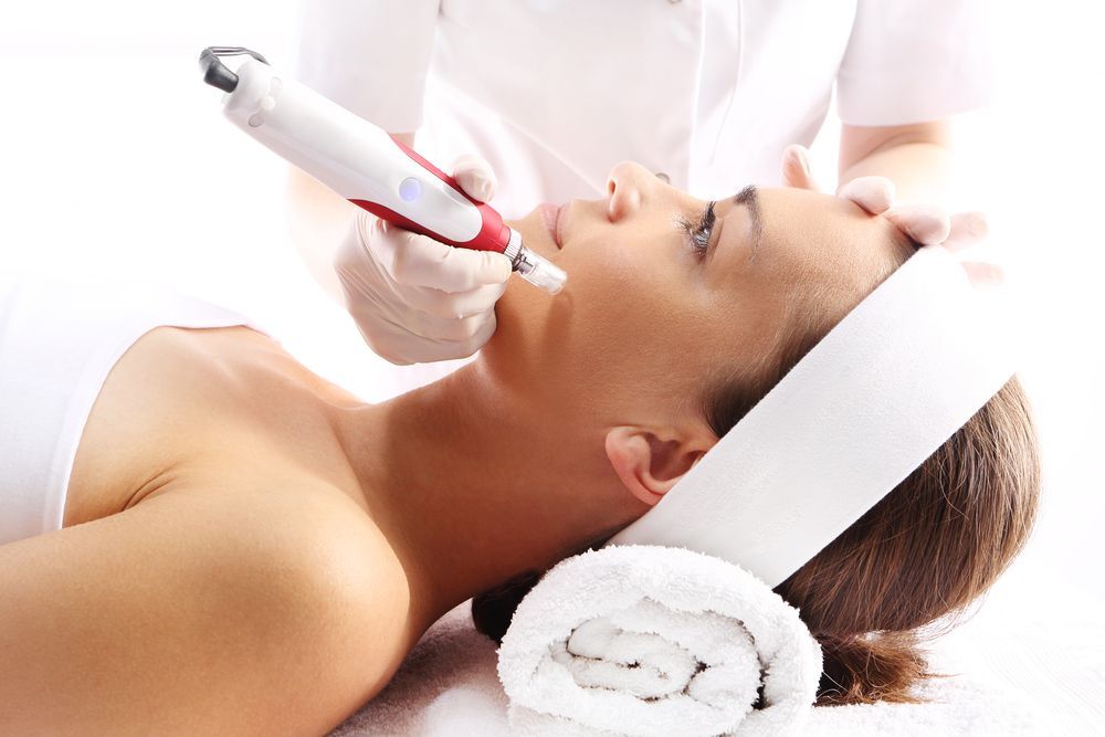 A Woman Is Getting A Facial Treatment At Skin Clinic — Mackay Skin Clinic In Sarina, QLD