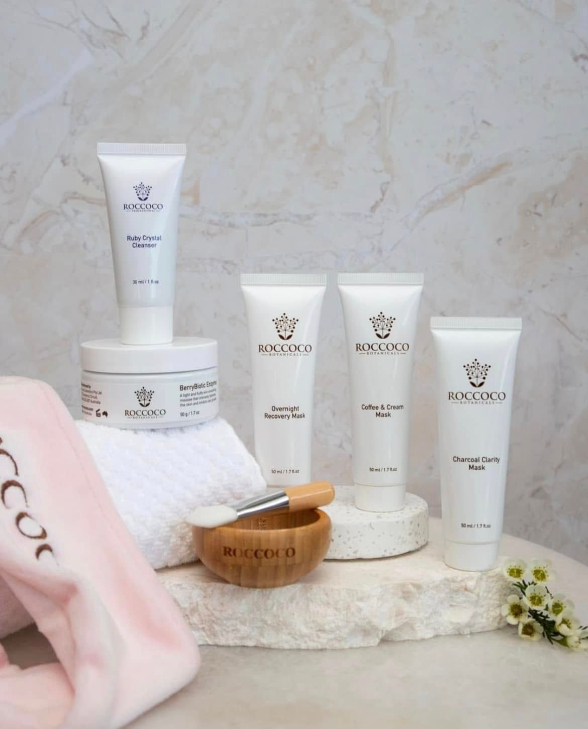 Roccoco Skincare Bottles and Jars on A Stone Display — Mackay Skin Clinic In North Mackay, QLD
