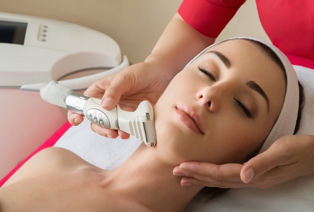 A Woman Is Getting A Facial Treatment At A Skin Clinic — Mackay Skin Clinic In North Mackay, QLD