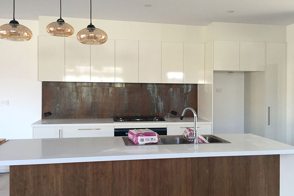 A Kitchen With White Cabinets and a Wooden Island — Imperial Build Co. in Coombs, ACT