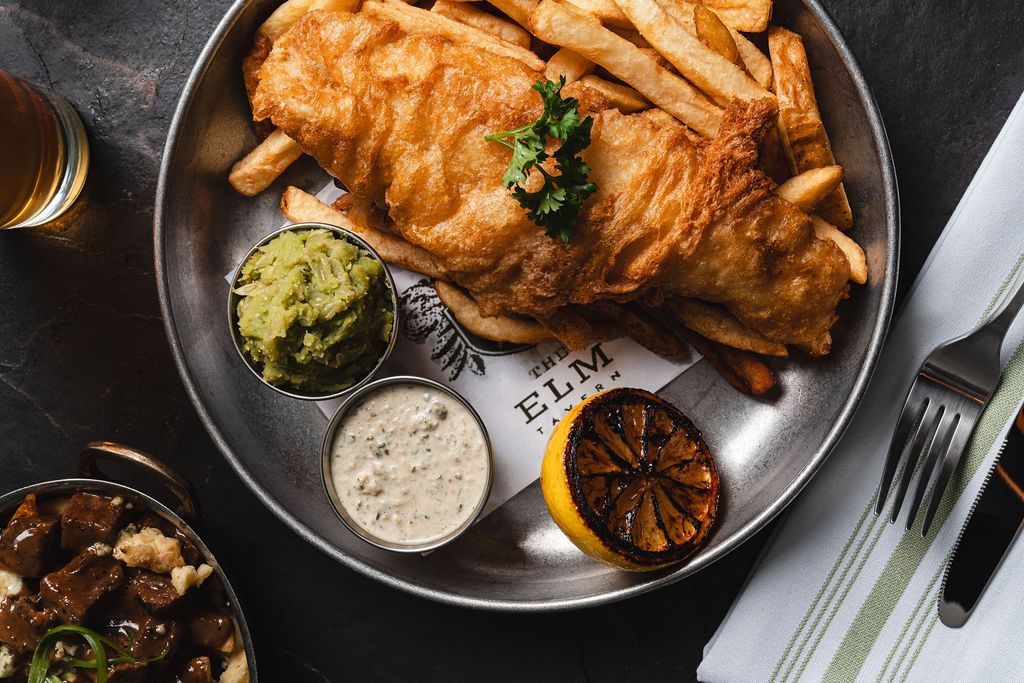 Fish and chips with marrowfat peas, tartar sauce and lemon.