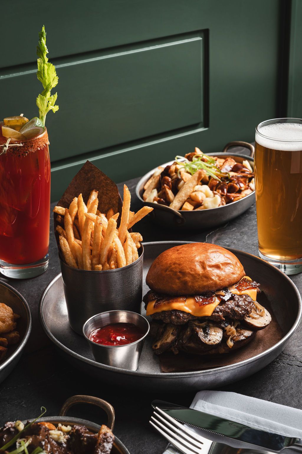 A hamburger, poutine, caesar, and beer.
