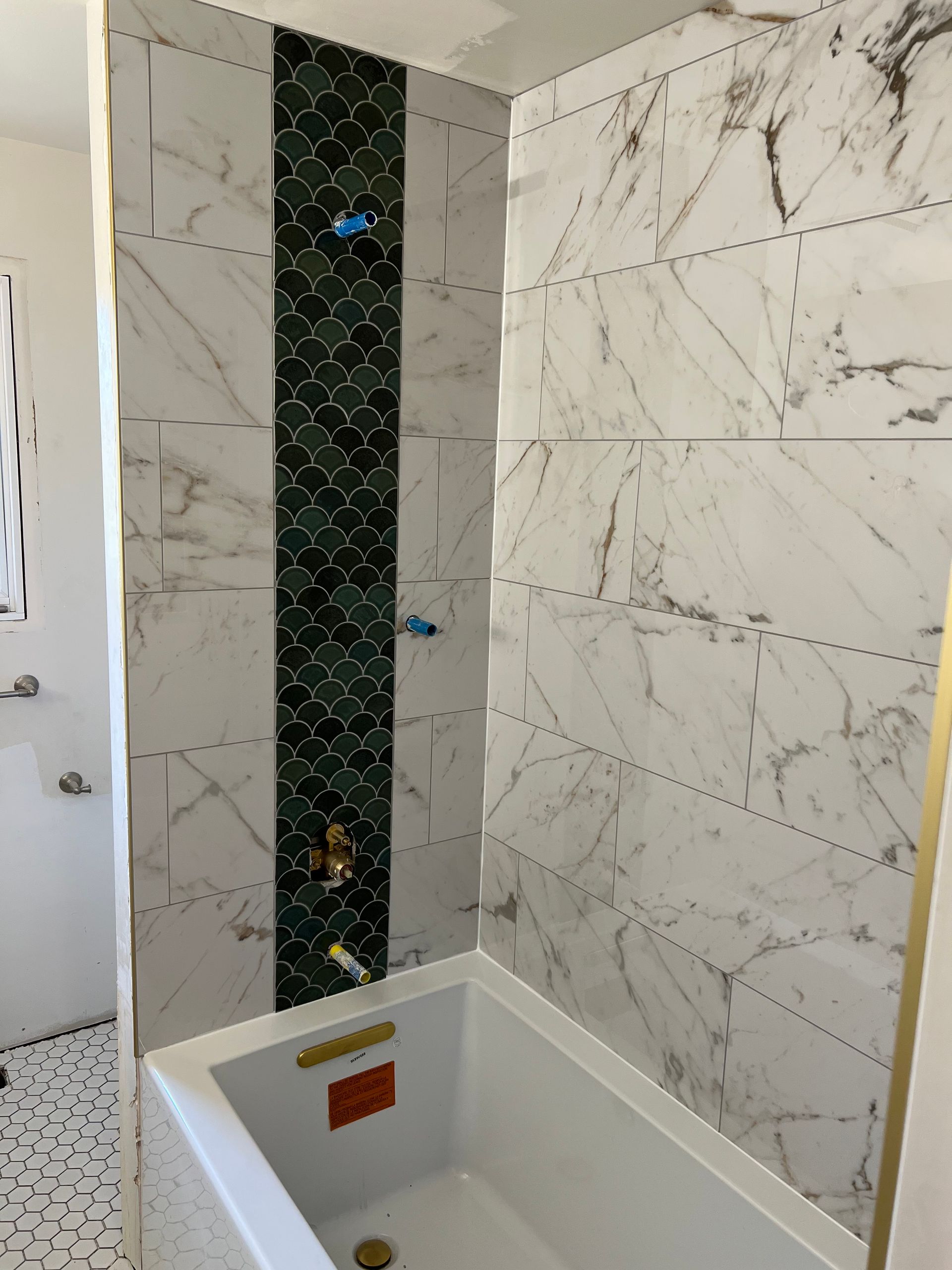 A Bathroom With Marble Tiles and a Bathtub