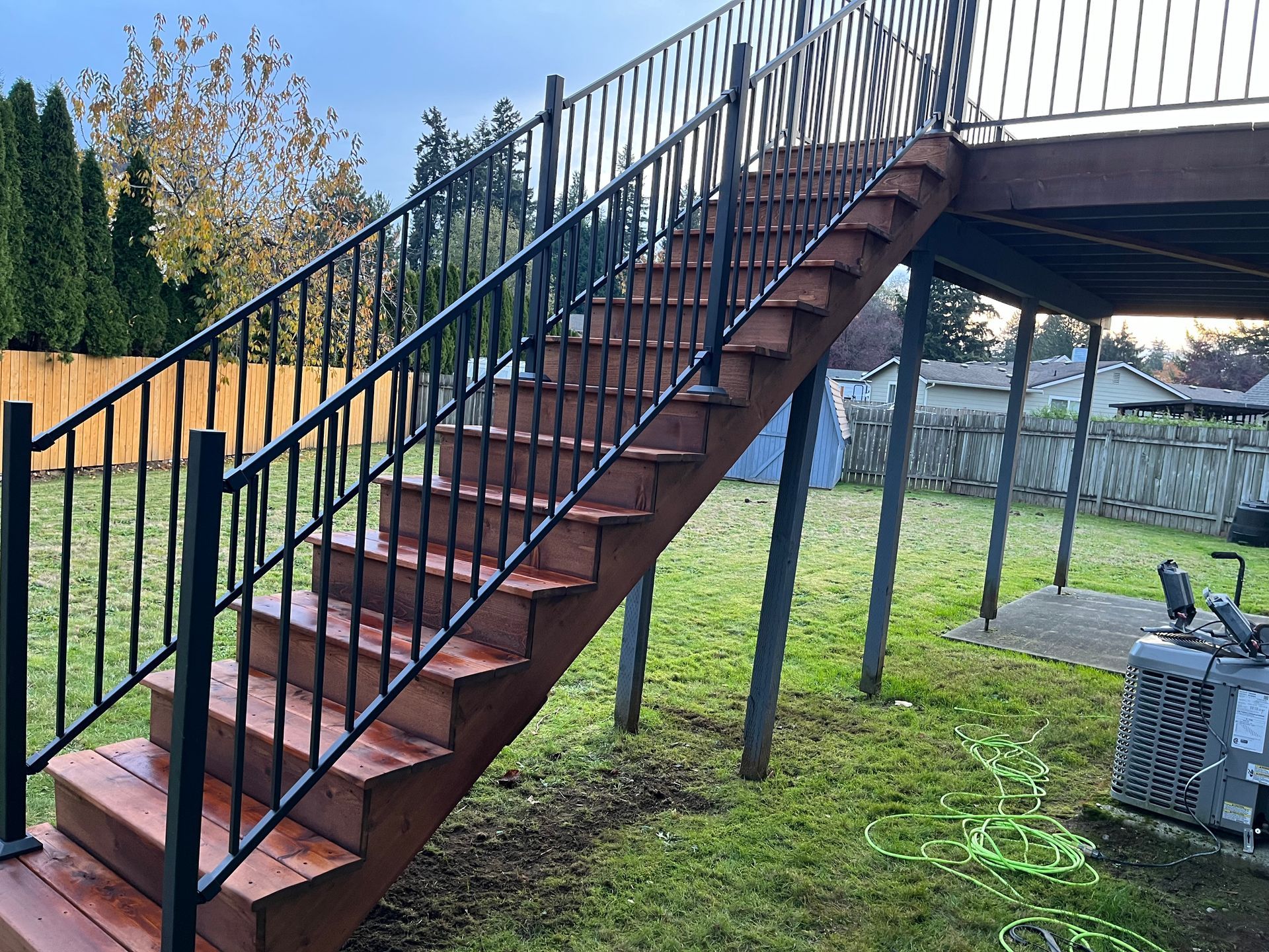 A Set of Stairs Leading Up to a Deck With a Metal Railing