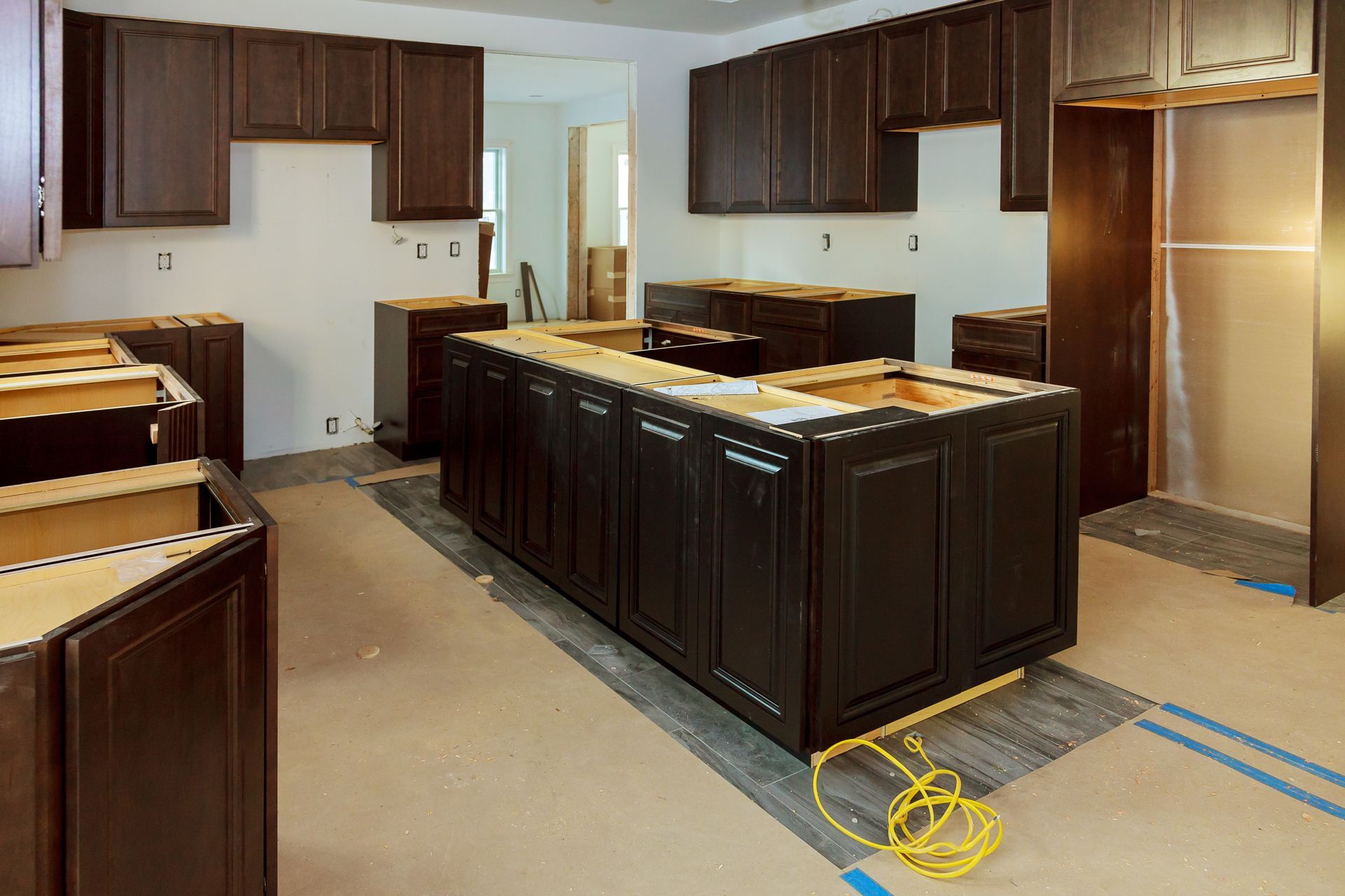A Kitchen Under Construction With a Large Island in the Middle