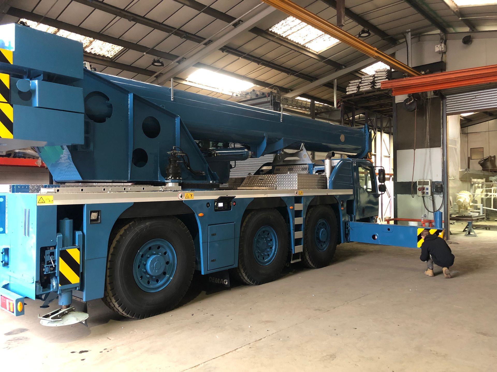 Spot blasting and painting the crane