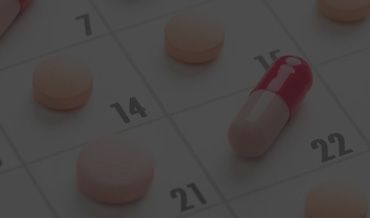 A close up of a calendar with pills on it