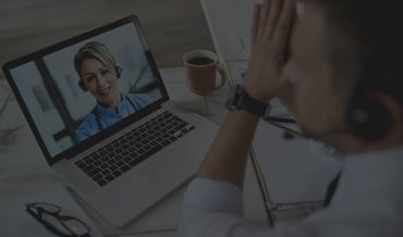 A man is having a video call with a doctor on his laptop.
