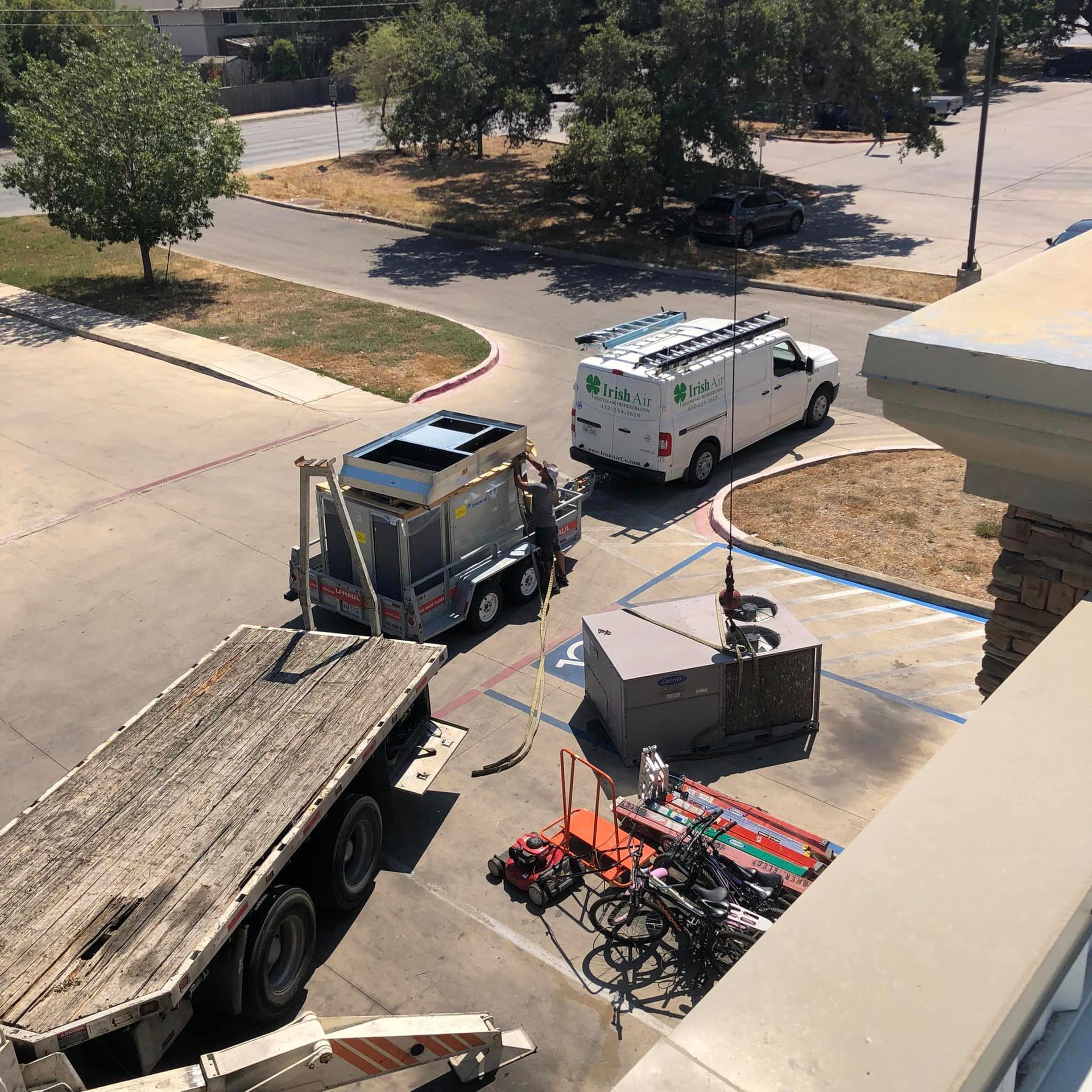 An aerial view of a parking lot with a truck and a van