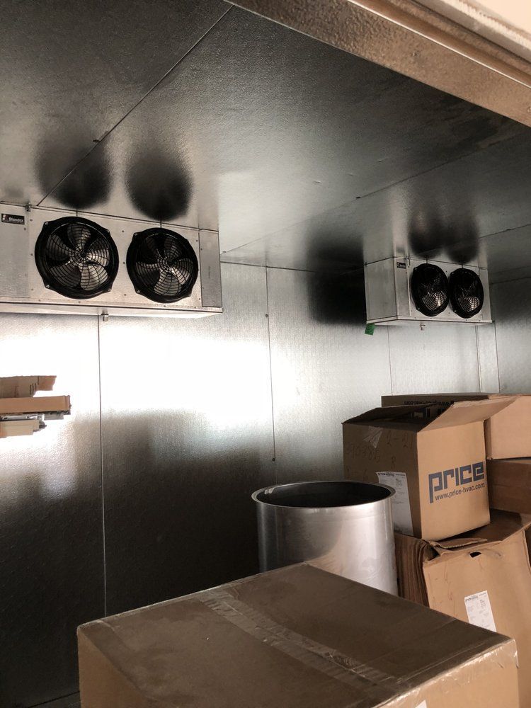 A room with boxes and fans on the ceiling.
