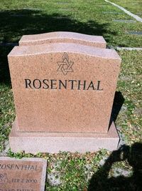 Pink granite gravestone engraved “ROSENTHAL” in a grassy cemetery