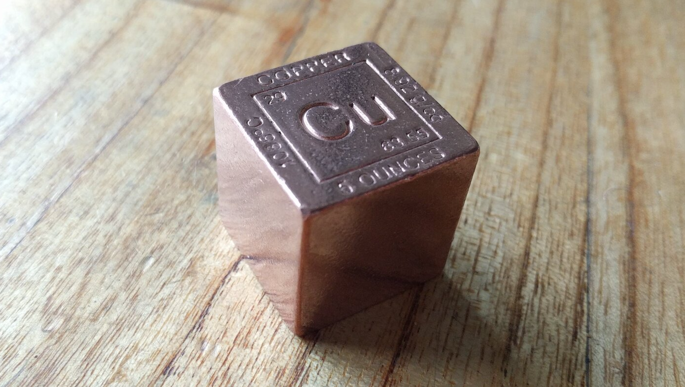 Copper cube with the periodic symbol 