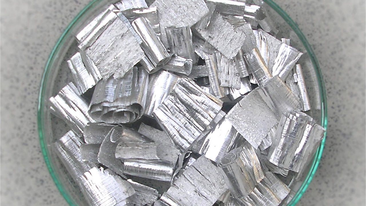 Silver metal shavings in a clear petri dish.