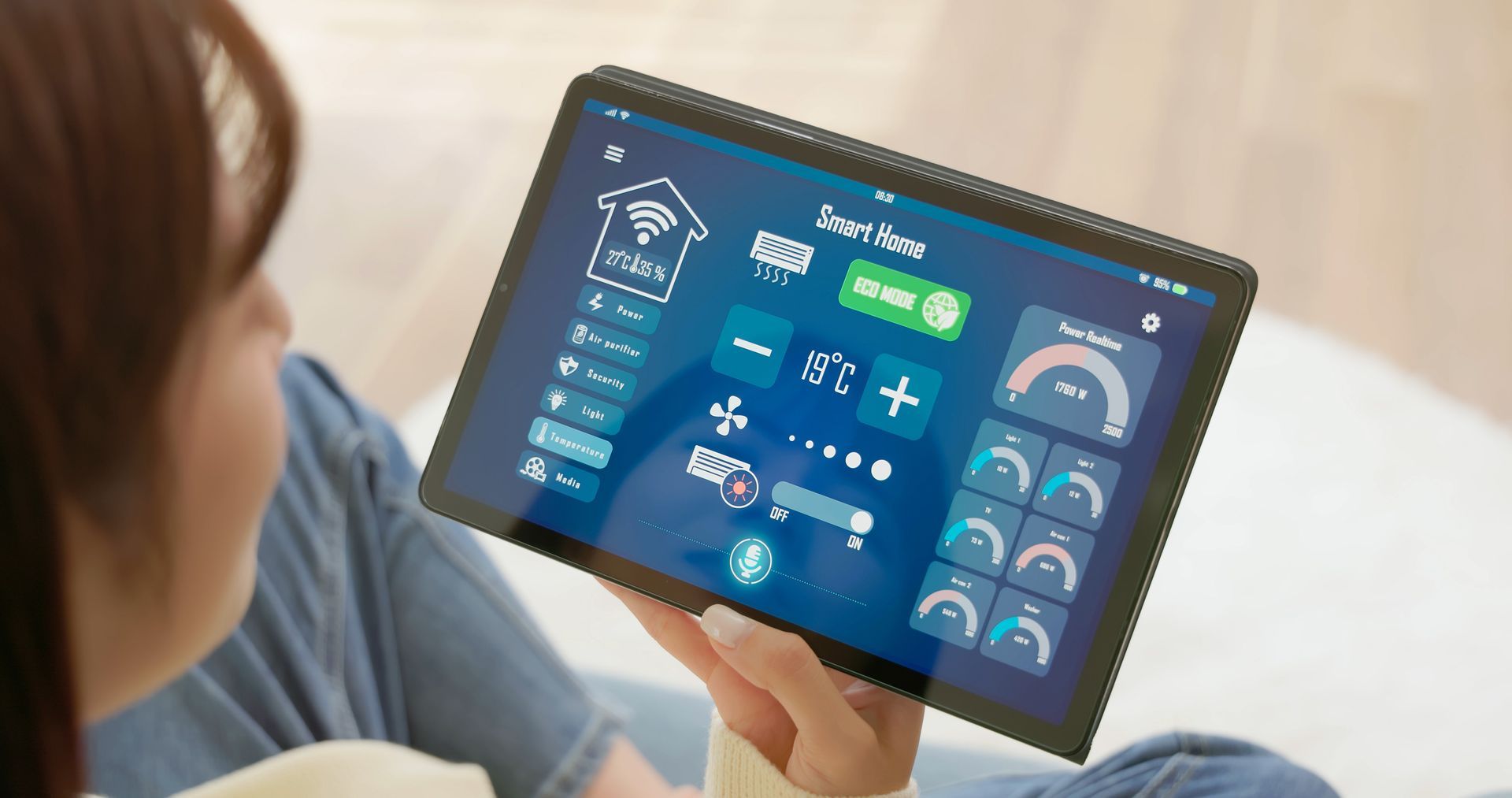 Woman uses smart home app on tablet to control lighting, climate, and security.