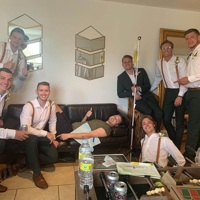 A group of men are posing for a picture in a living room