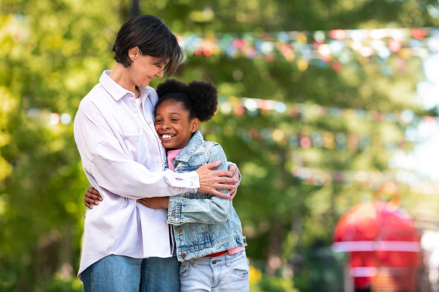 A younger person's hands gently hold an older person's hands, offering comfort and support.