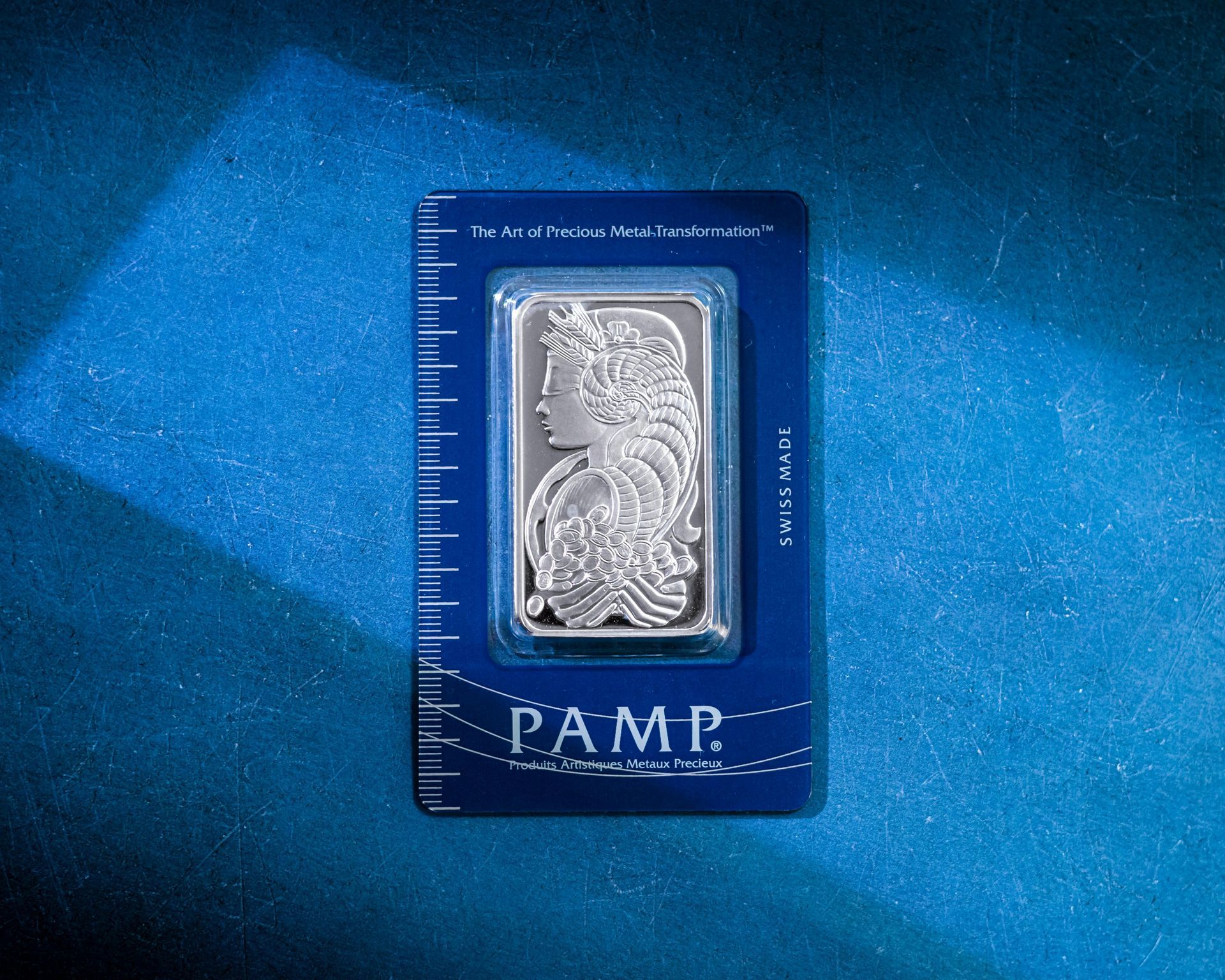 A PAMP Suisse silver bullion bar in a protective blue assay card, featuring the Lady Fortuna design.