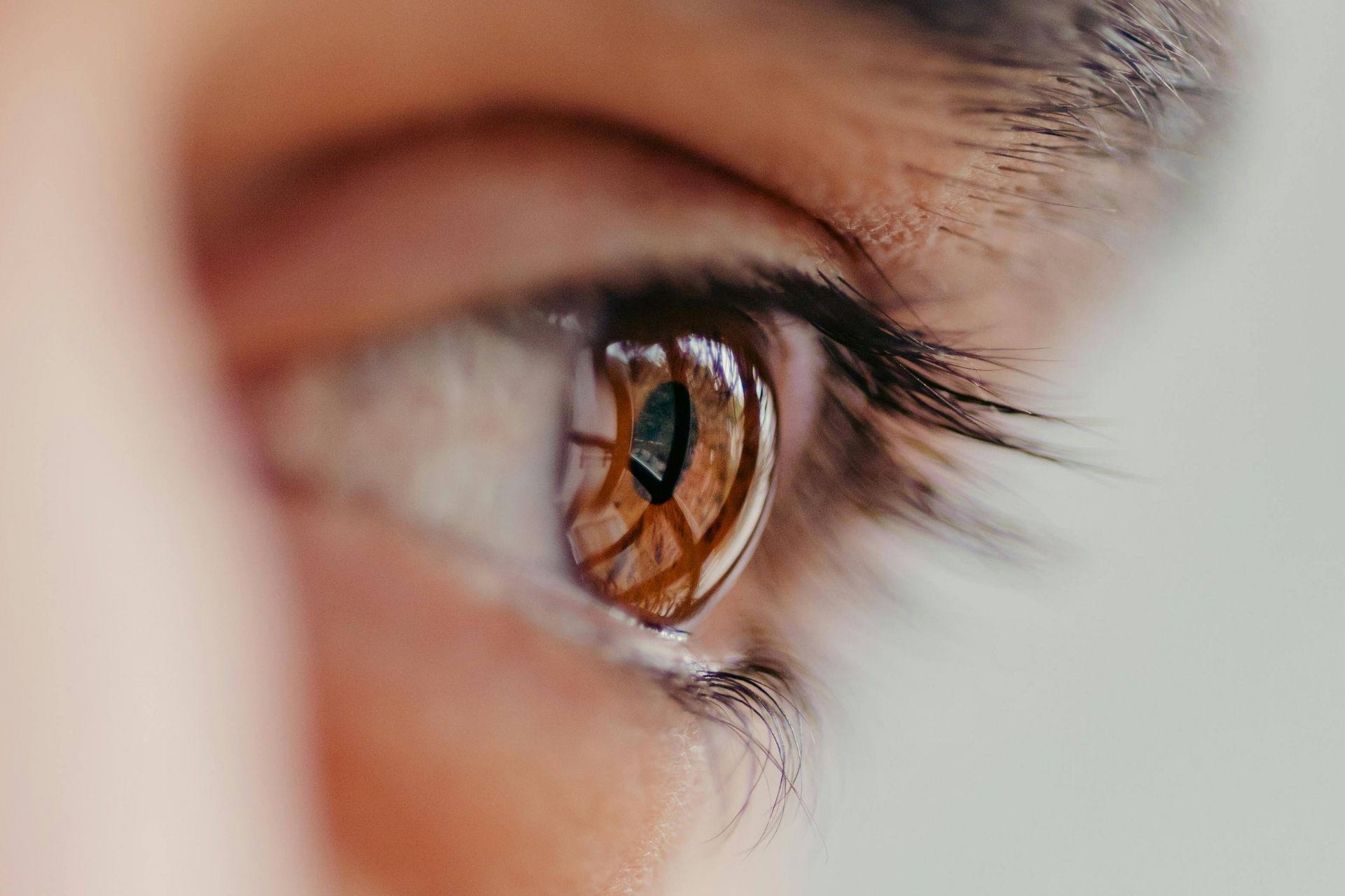 A man is looking through a microscope at a woman 's eye