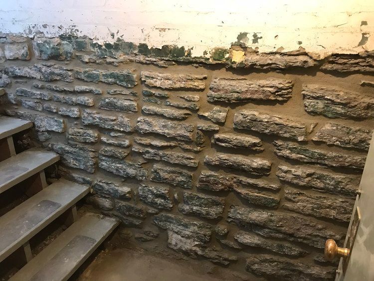 A stone wall with stairs leading up to it
