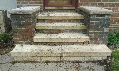 A set of stairs leading up to a brick building